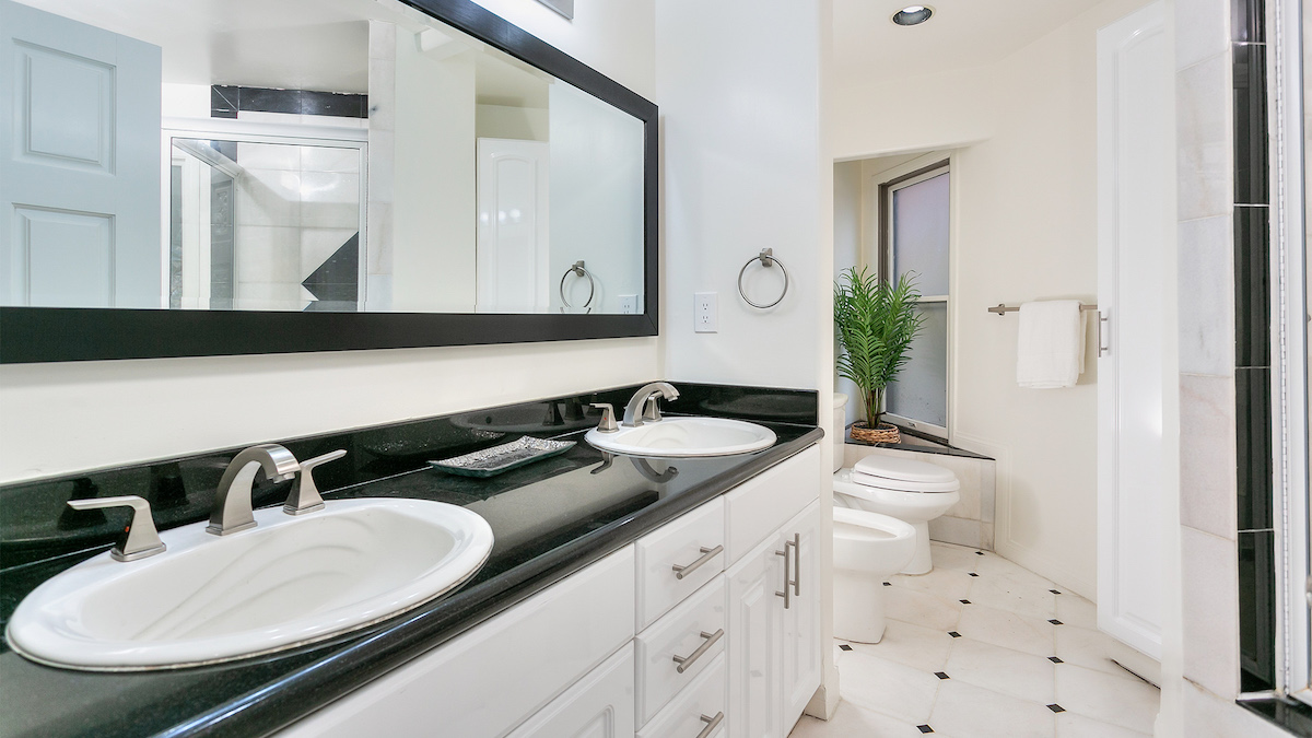 black-vanity-white-tile-flooring-bathroom-design